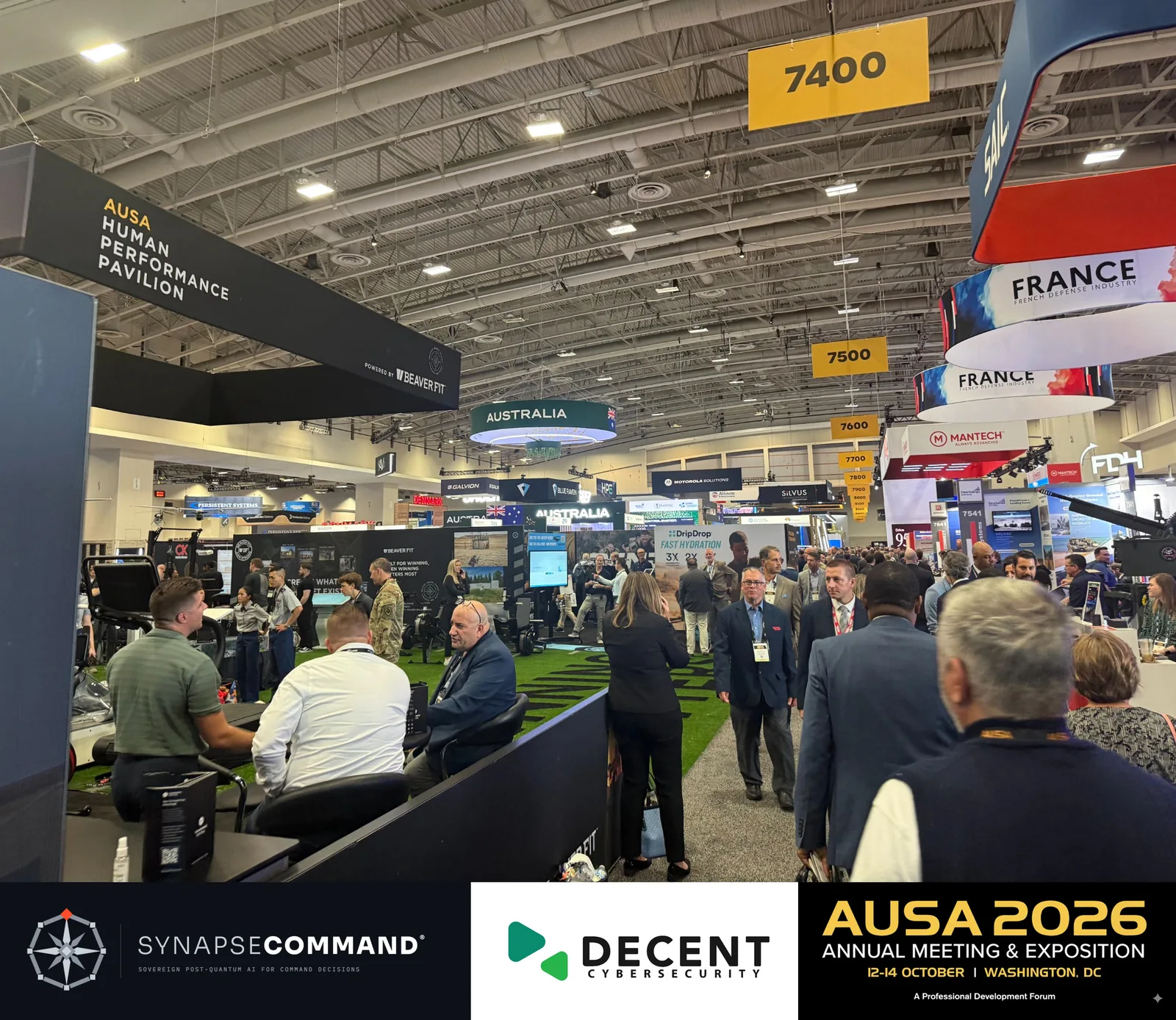 Visitors in an AUSA 2026 aisle beneath French and Australian exhibition signs.