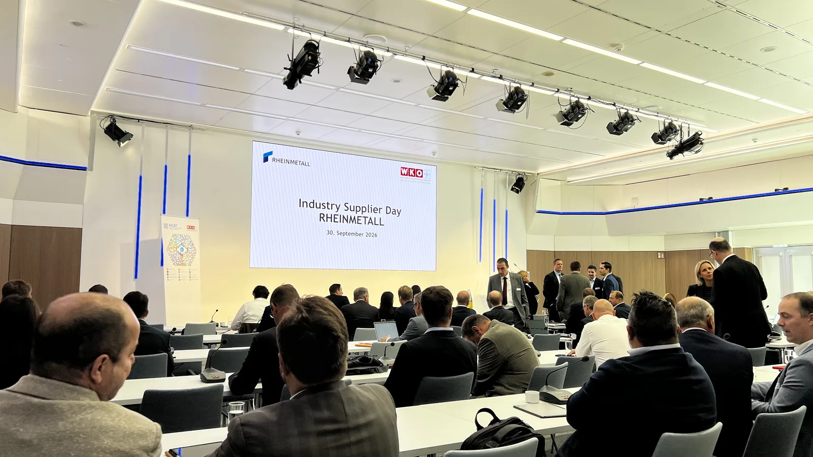 Delegates seated at WKO in Vienna beneath the Rheinmetall Industry Supplier Day screen dated 30 September 2026.